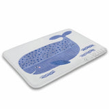 Coral velvet bath rug with blue whale illustration for bathroom