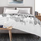 Black and white misty forest flannel blanket with "Adventure Never Ends" text for home decor