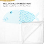 White baby blanket with blue fish design. Class, Warmth, Comfort In One Blank made from fleece fabric.
