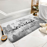 Coral velvet bath rug with "The adventure never ends" text and forest scene for bathroom