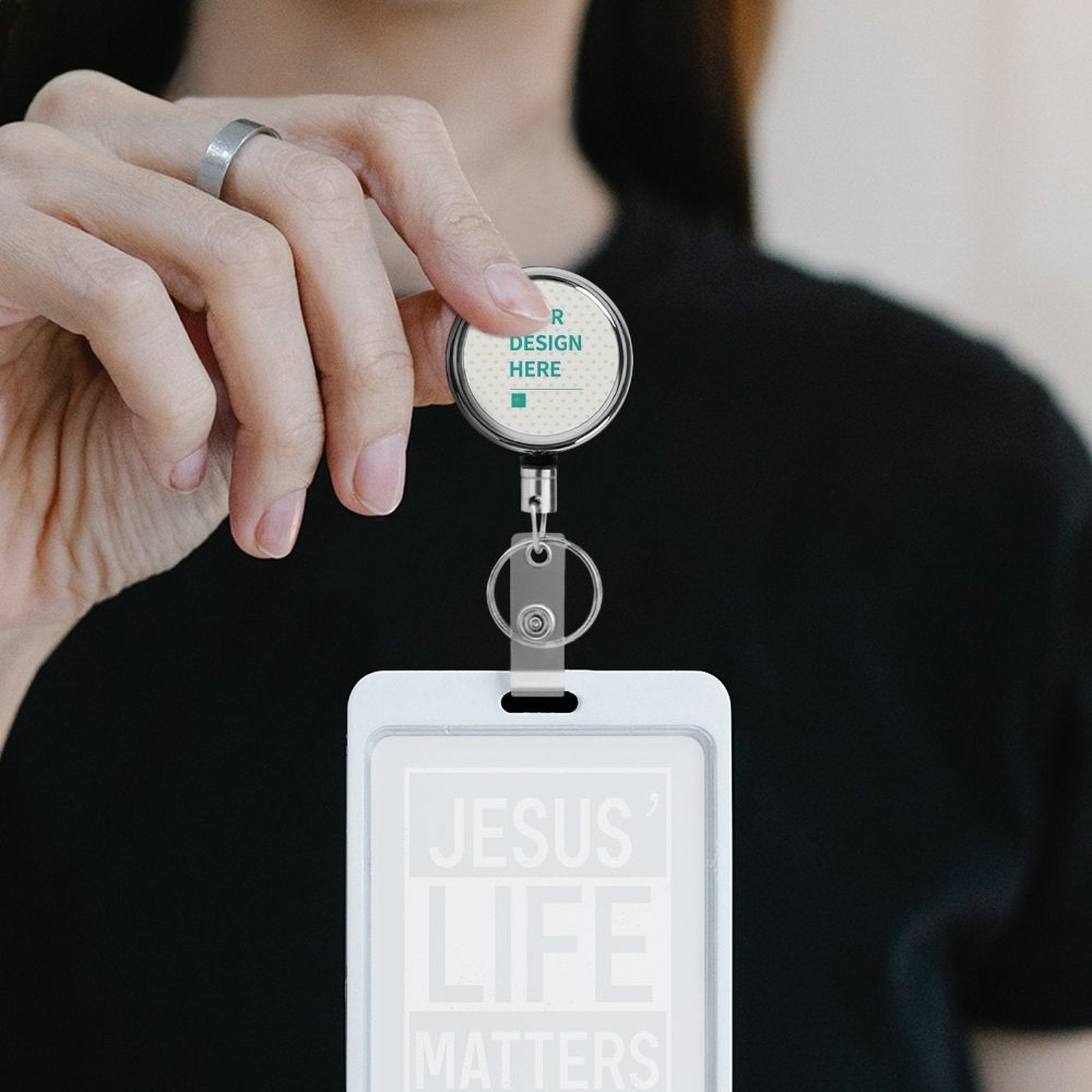 Personalized stainless steel badge reel holder with 'R DESIGN HERE' and 'JESUS LIFE MATTERS' ID card.