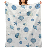 Navy shells fleece blanket featuring seashells and starfish design, cozy and soft for bed or sofa