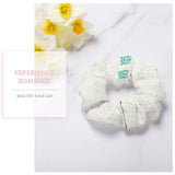 Custom white scrunchie with yellow polka dots and "DESIGN HERE" text. Comfortable polyester hair tie for women.