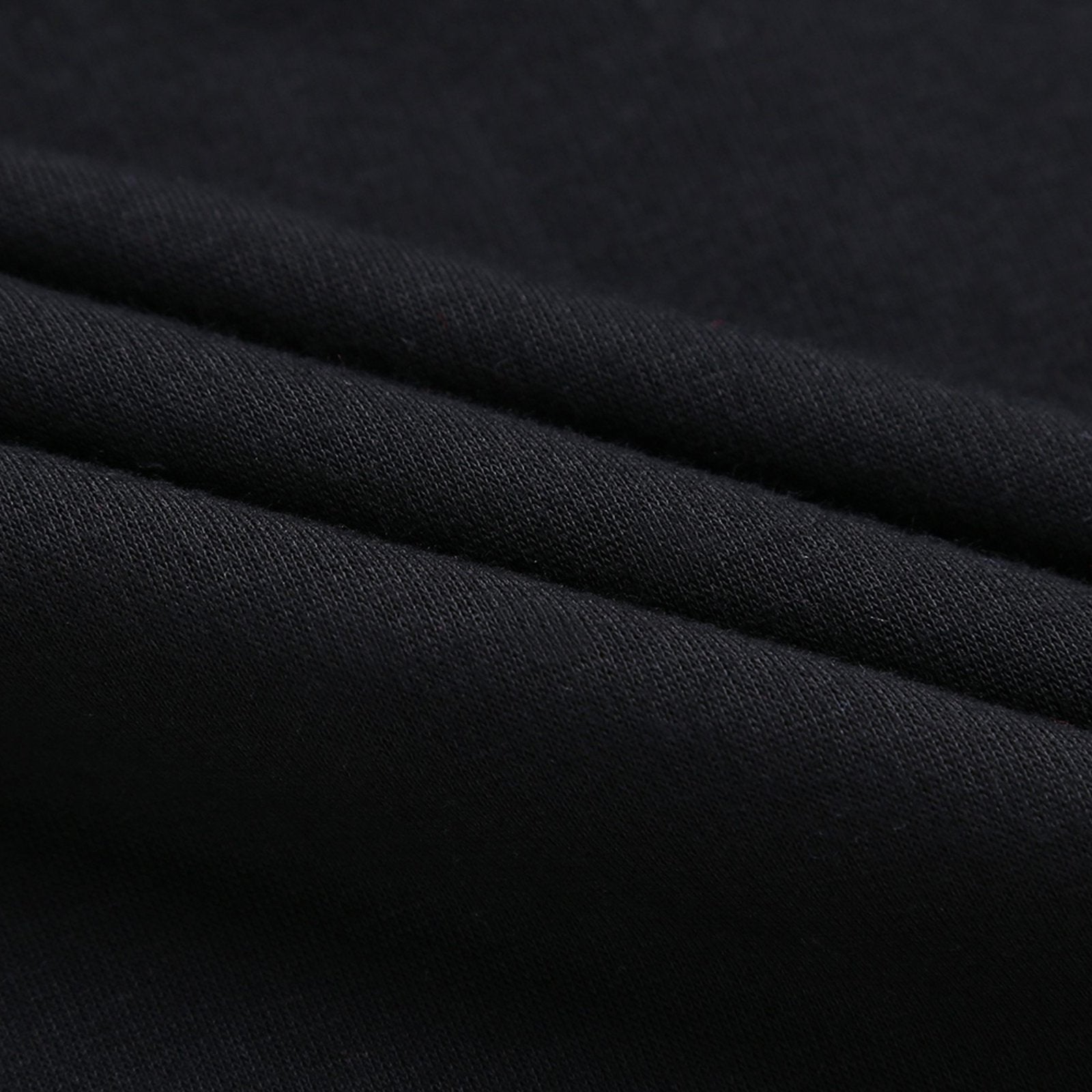 Black cotton fabric detail for youth hoodie, showcasing soft texture and material quality