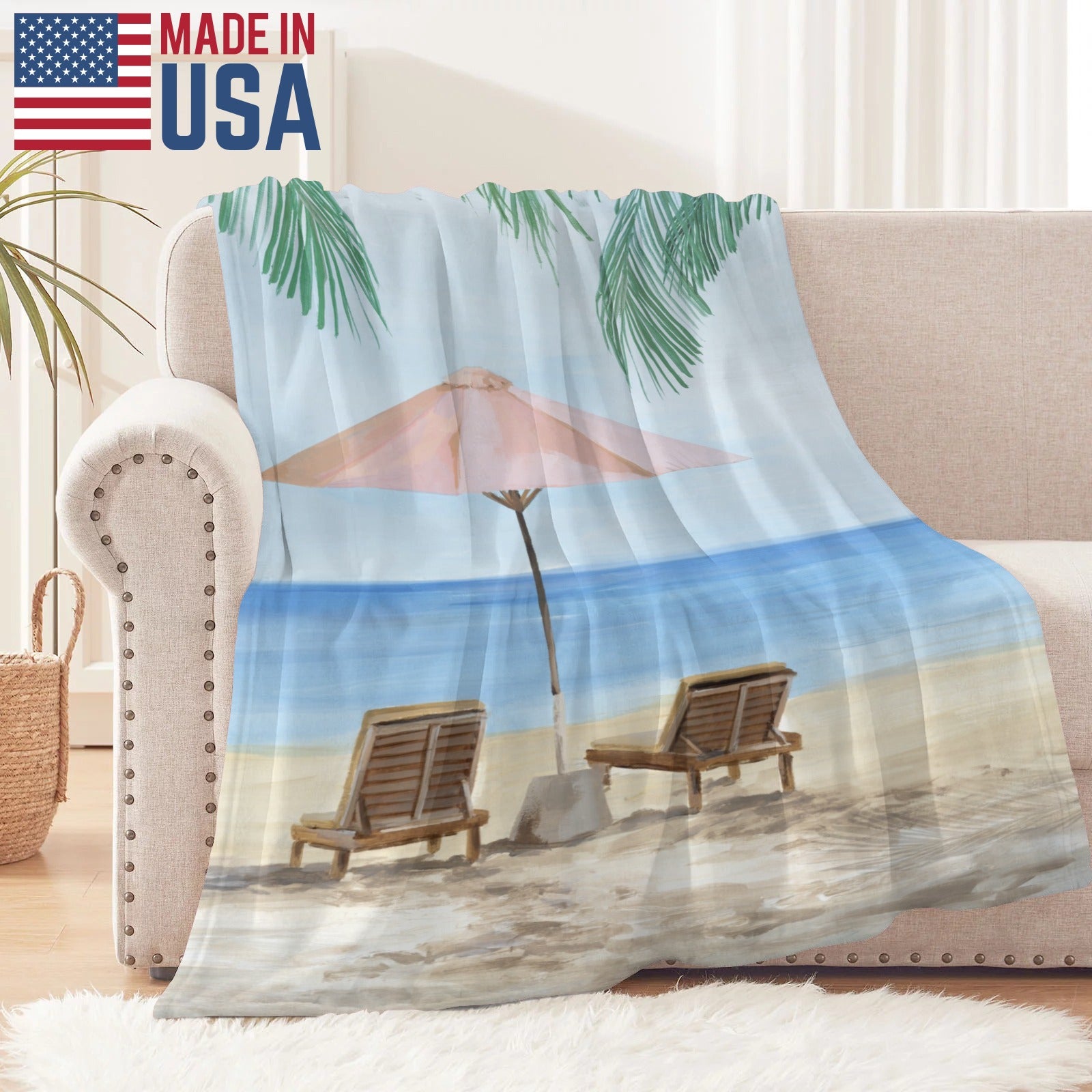 Beach scene flannel blanket on sofa, Made in USA. Lightweight and stylish, perfect for bed or couch.