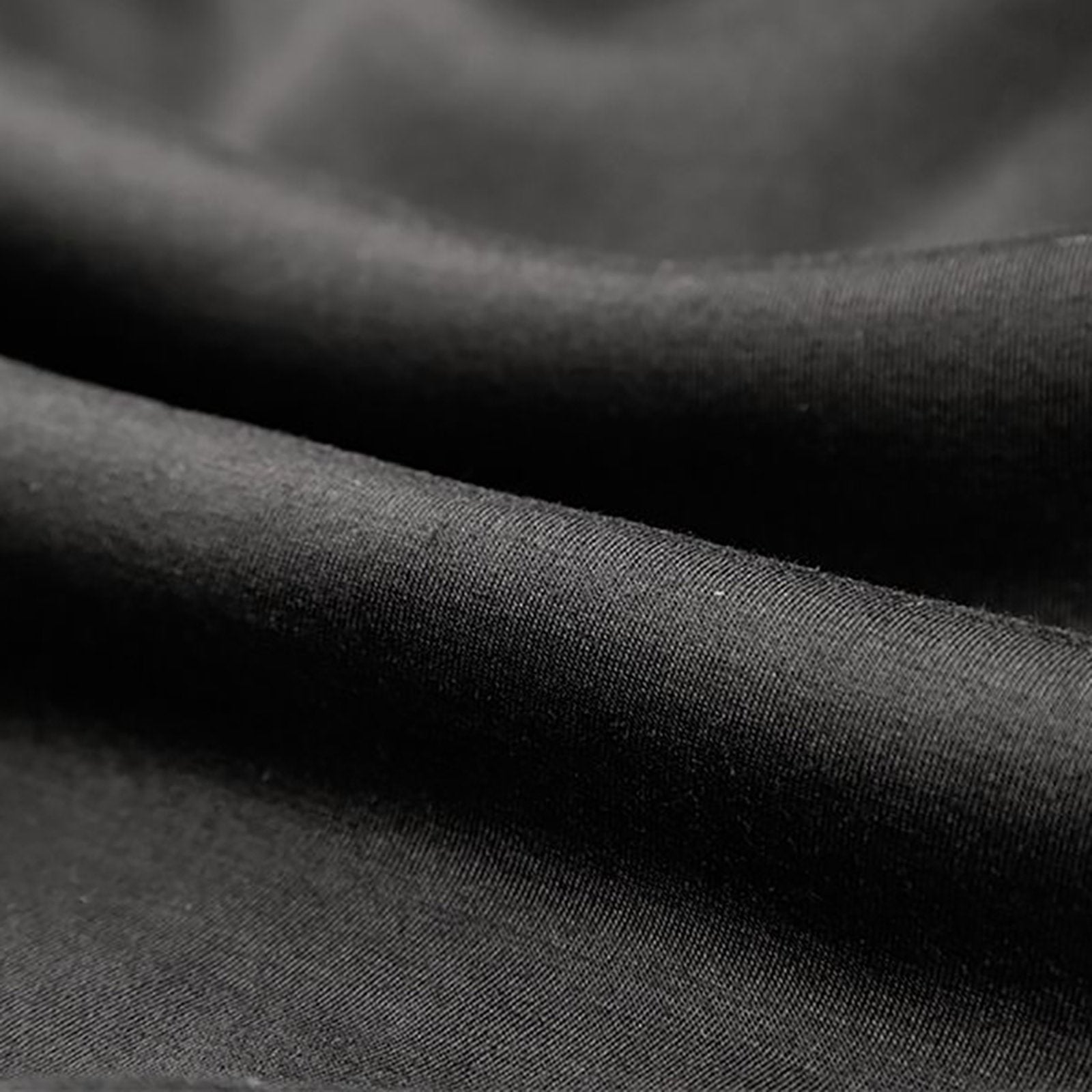 Black polyester fabric detail of custom hoodie, showing texture and material quality. Personalized sweatshirt material.