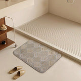 Coral velvet bath rug with gold floral pattern in bathroom setting, non-slip door rug