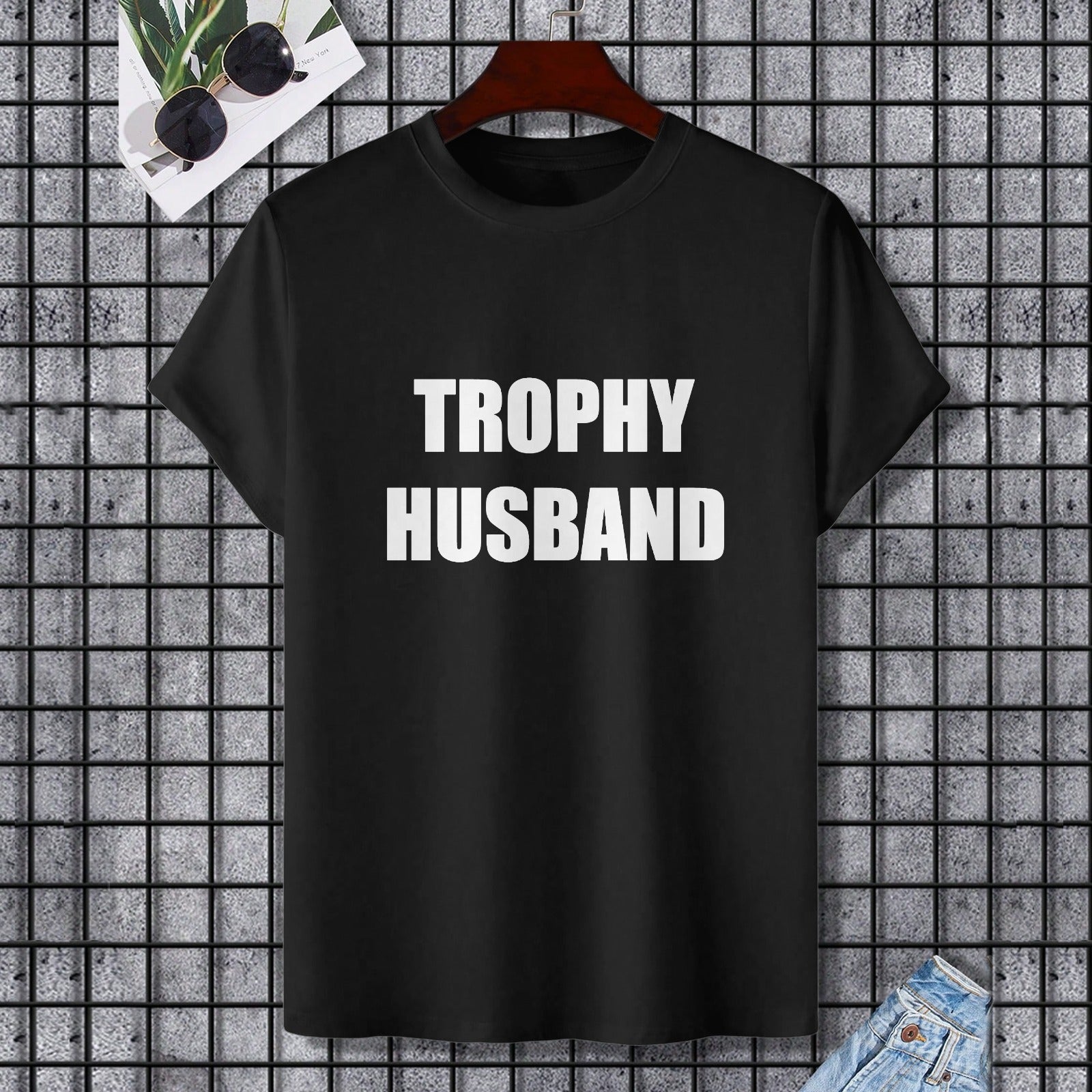 Black Gildan unisex T-shirt with "TROPHY HUSBAND" printed in white, perfect for expressing individuality