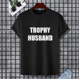 Black Gildan unisex T-shirt with "TROPHY HUSBAND" printed in white, perfect for expressing individuality