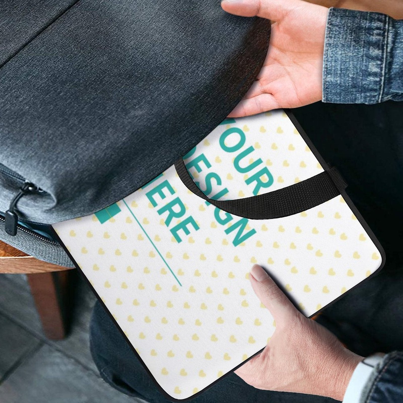 Personalized laptop bag with "YOUR DESIGN HERE" design being placed into a backpack, laptop sleeve gift