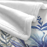 Soft white flannel blanket with blue tropical plant design, polyester made in USA, cozy home decor.