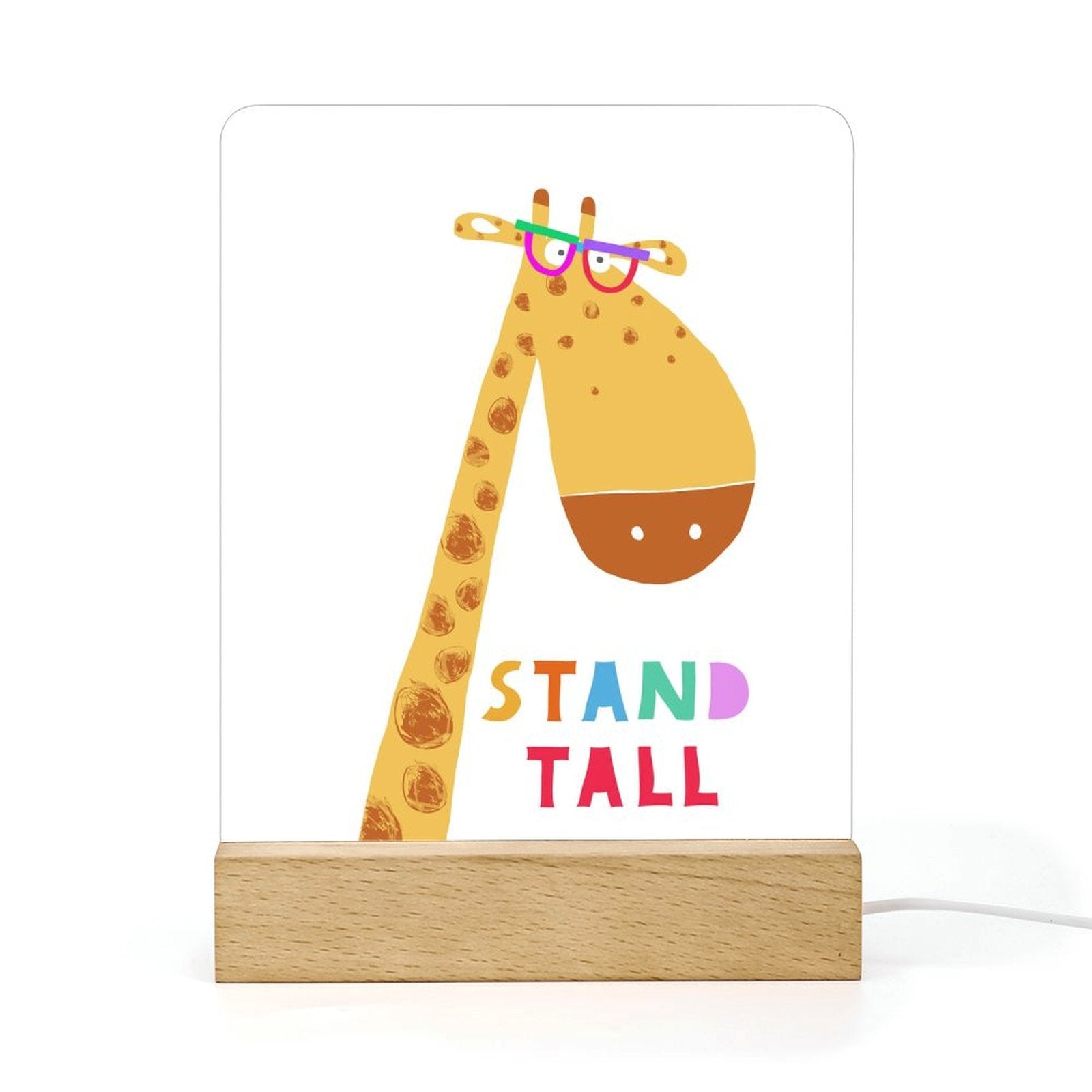Acrylic night light with giraffe design, wooden base, and 'STAND TALL' text, perfect for kids' room decor.