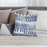 Blue brushstroke throw pillow cover on bed. Modern home decor for sofa, couch, or living room. Short plush material.