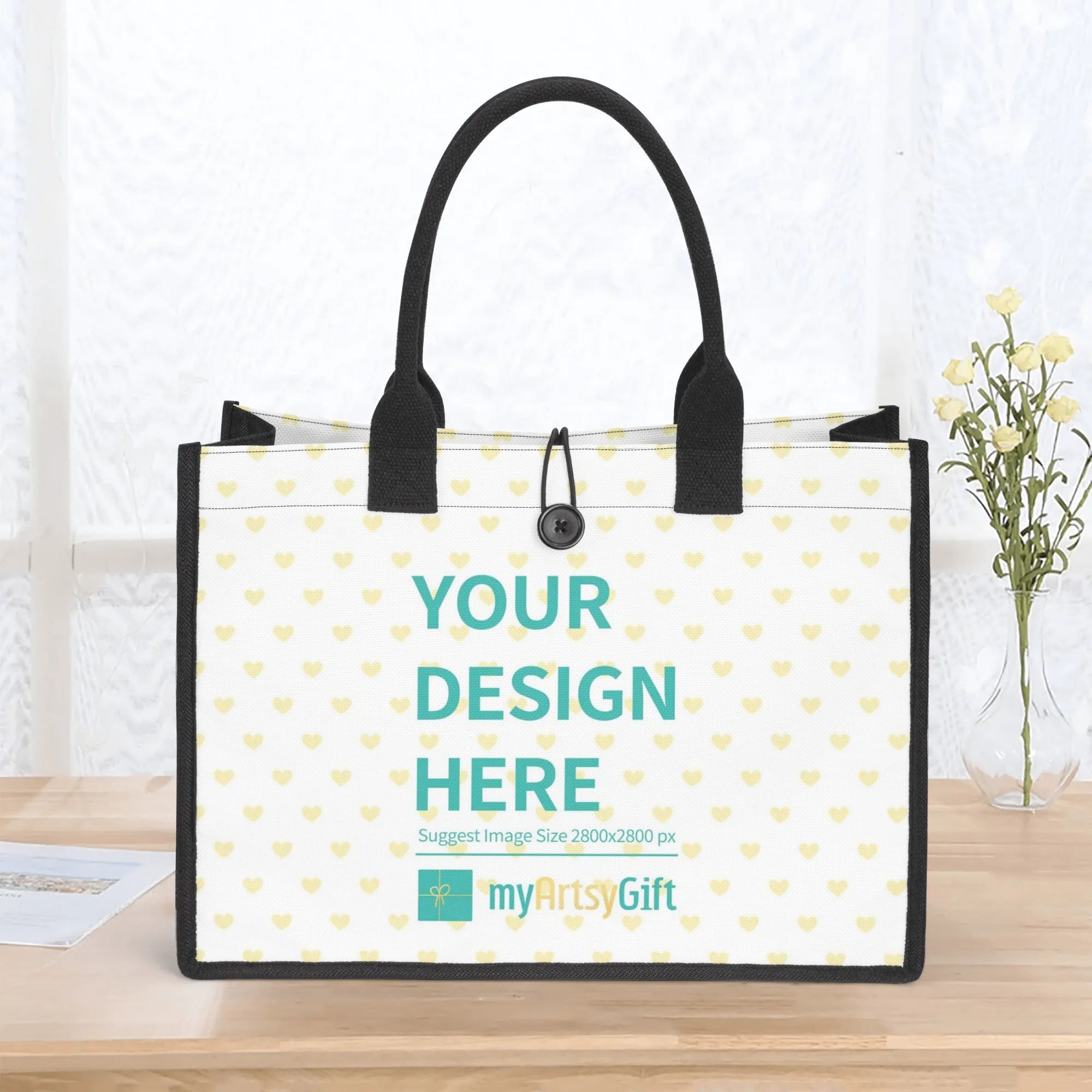 Customizable canvas tote bag with heart pattern, black handles, and 'Your Design Here' text from MyArtsyGift