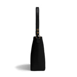 Black PU leather bucket bag, side view, with a handle, gold hardware, travel tote shoulder bag