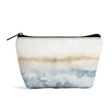 Girls' wristlet bag with an abstract watercolor design in blue and tan.