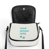 Customizable PU leather saddle bag with 'YOUR DESIGN HERE' on white heart pattern, black accents, and black adjustable strap