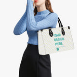 Personalized tote bag with 'YOUR DESIGN HERE' text, black handles, and heart pattern; perfect for women and girls.