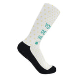 Customizable crew sock with "YOUR DESIGN HERE" text, yellow hearts, and black accents, perfect for gifts