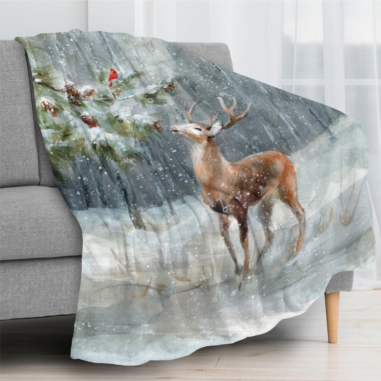 Winter snow forest deer blanket on sofa. Cozy scene with deer and cardinal in a snowy woodland setting.