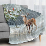 Winter snow forest deer blanket on sofa. Cozy scene with deer and cardinal in a snowy woodland setting.