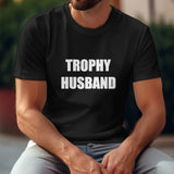 Black Gildan Unisex T-shirt with "TROPHY HUSBAND" print. Comfortable cotton tee for husbands, perfect gift.