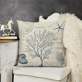 Throw pillow cover with blue coral and seashell design on a vintage map. Soft plush, decorative pillow for living room.