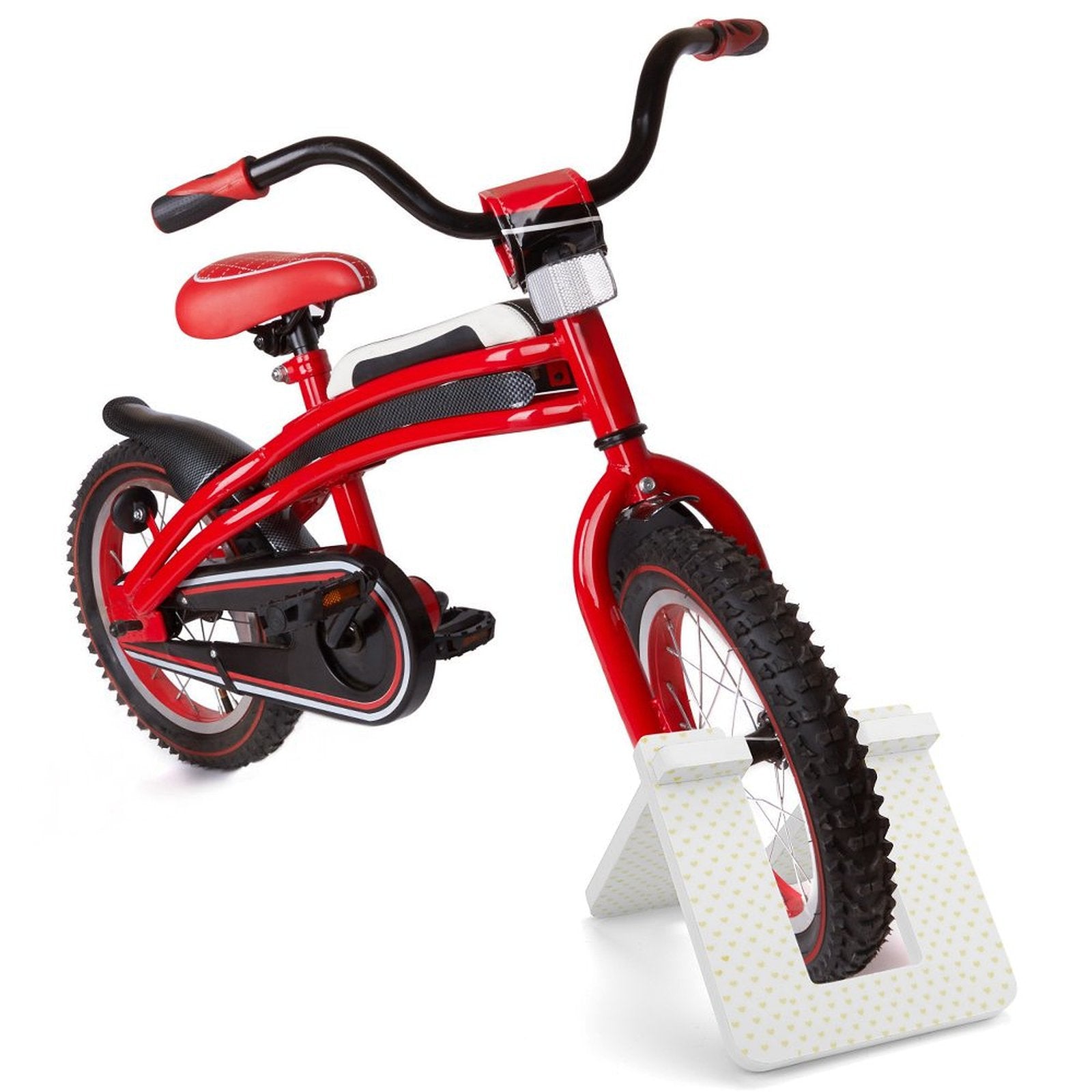 Red balance bike on white PVC stand, heart pattern, for safe parking and storage