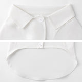White pet shirt vest, close-up details of collar, button, and hemline. Breathable and stylish dog or cat apparel.