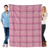 Buffalo plaid flannel blanket in pink and white, held by two people, perfect for cozy indoor use.