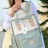 Custom keychain with 'YOUR DESIGN HERE' hanging from a backpack, personalized gift idea