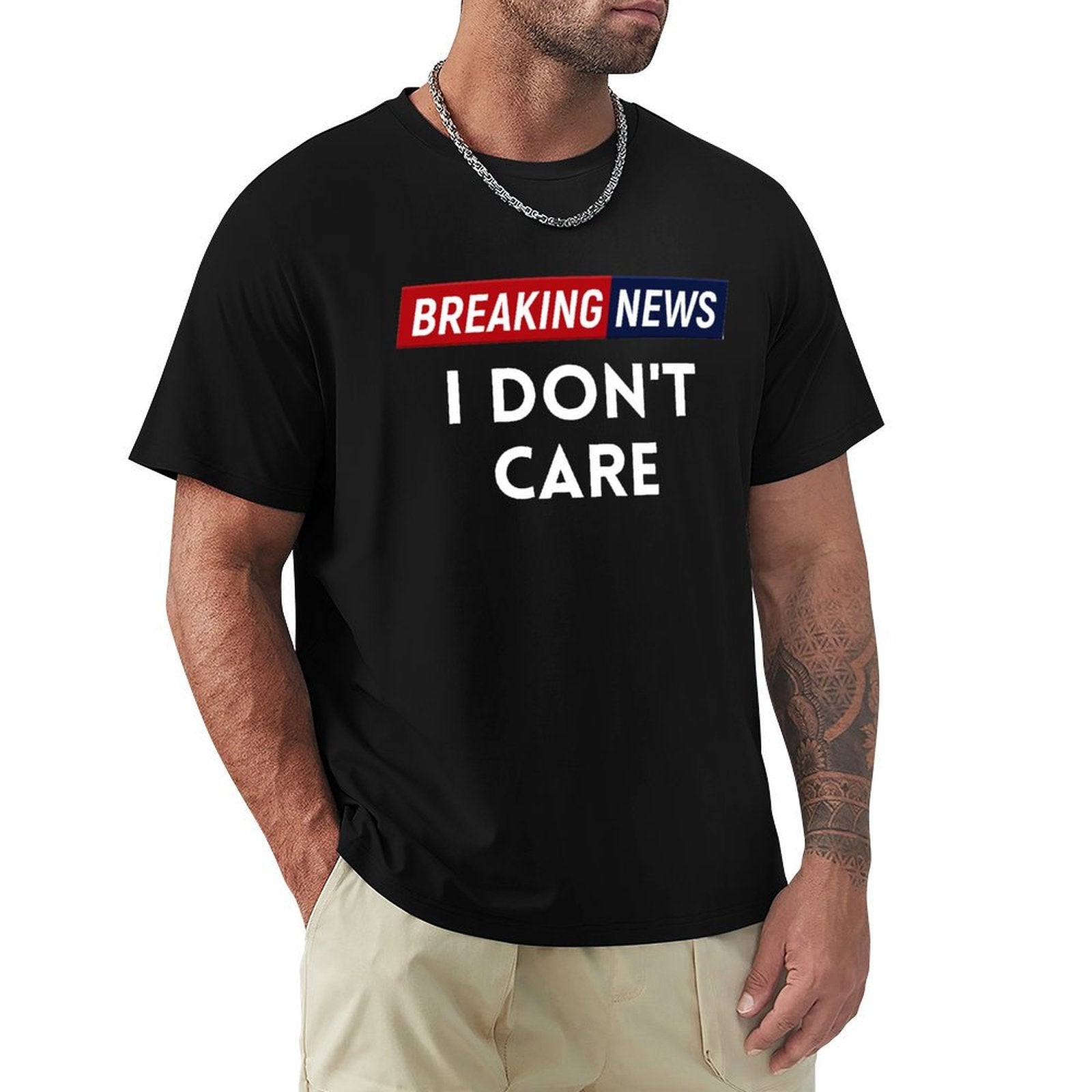 Men's black crew neck t-shirt with the text 'BREAKING NEWS I DON'T CARE'. Comfortable classic tee for men.