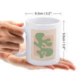 White ceramic coffee mug with green abstract design Shape Up IV by Wild Apple, a personalized gift idea from MyArtsyGift