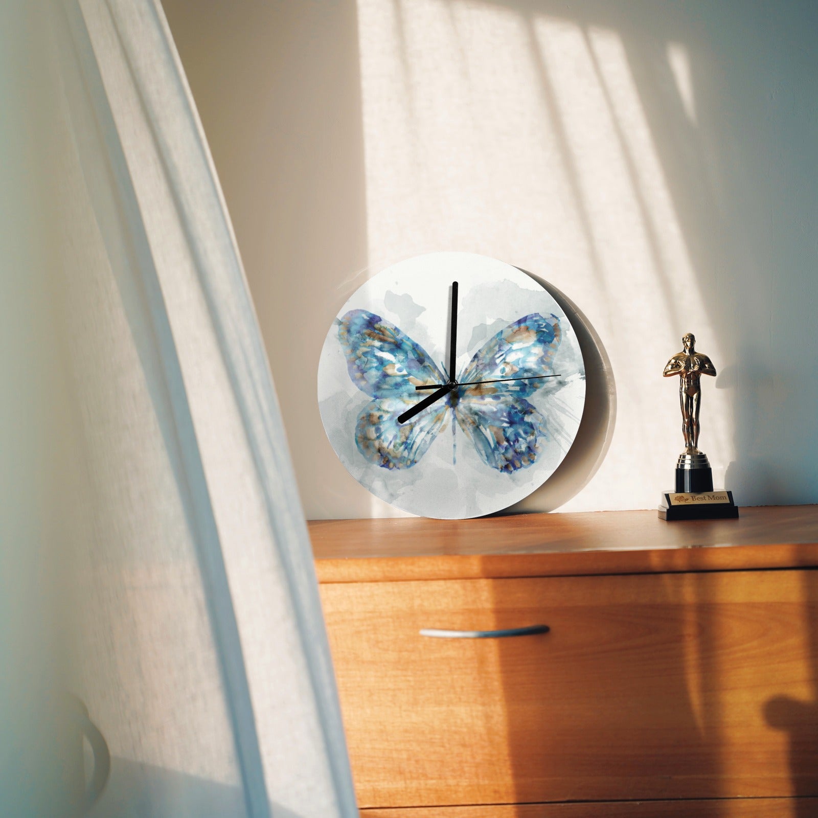 Modern blue butterfly MDF wall clock on a wooden surface, ideal for living room, kitchen, or office decor.