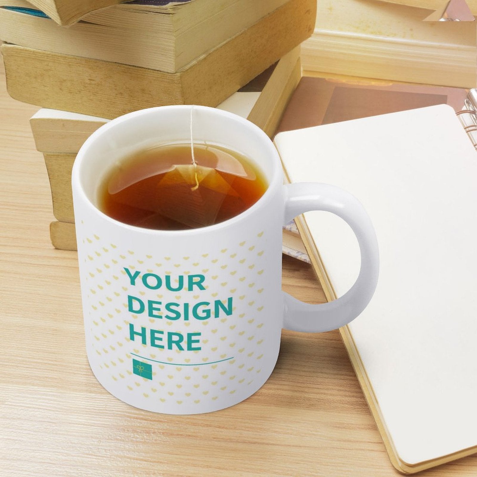Customizable white ceramic mug with "YOUR DESIGN HERE" text, perfect for personalized gifts and tea