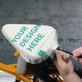 Custom bike seat rain cover with 'YOUR DESIGN HERE' design, waterproof and adjustable, protecting from rain and sun.