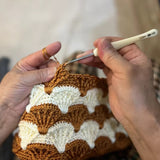 Hand crocheting a wool hat with brown and white scallops, Mom's handmade winter hat