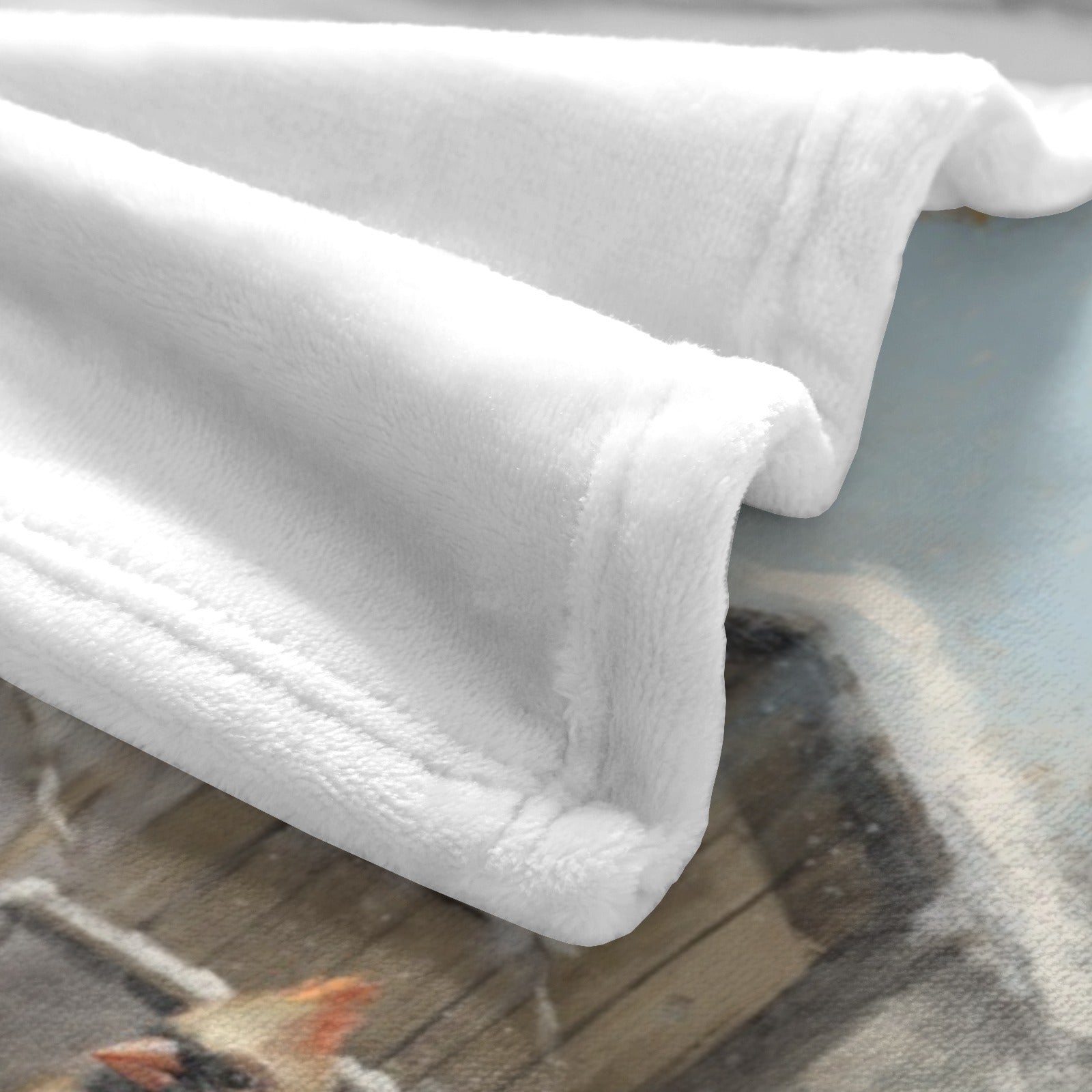 White flannel blanket corner, showcasing soft texture and cardinal bird design, perfect for home decor and gifts.