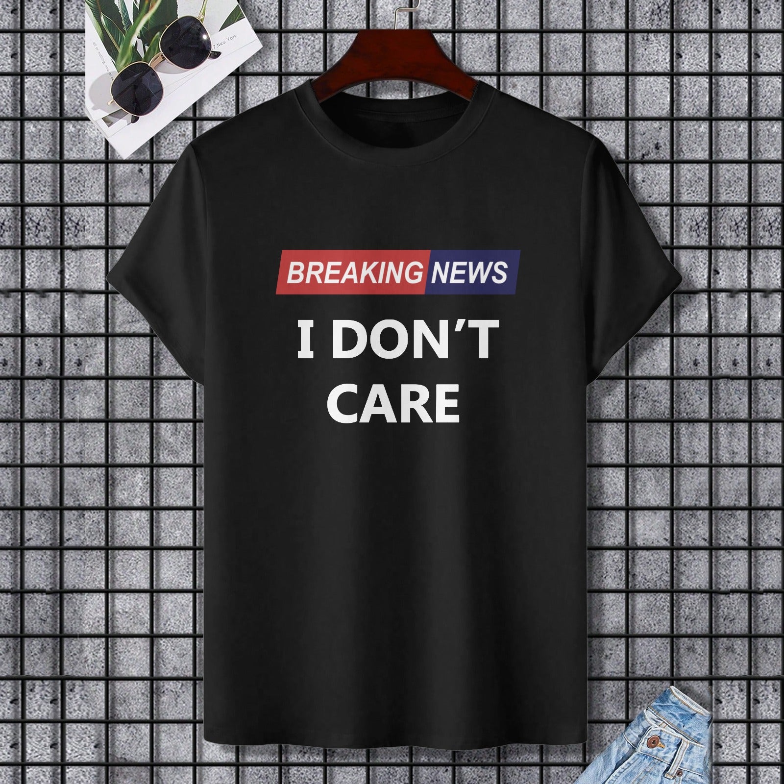 Black cotton T-shirt with "I DON'T CARE" print. Gildan Unisex Tee. Perfect for expressing individuality.
