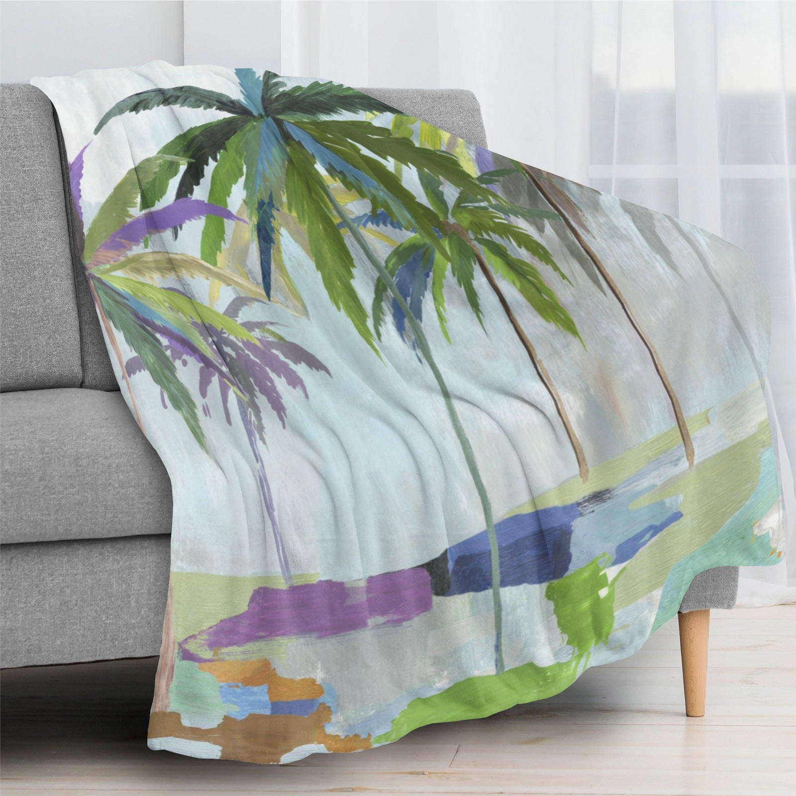 Abstract coconut palm trees flannel blanket draped over a gray sofa. Made in USA, perfect for bed or couch.