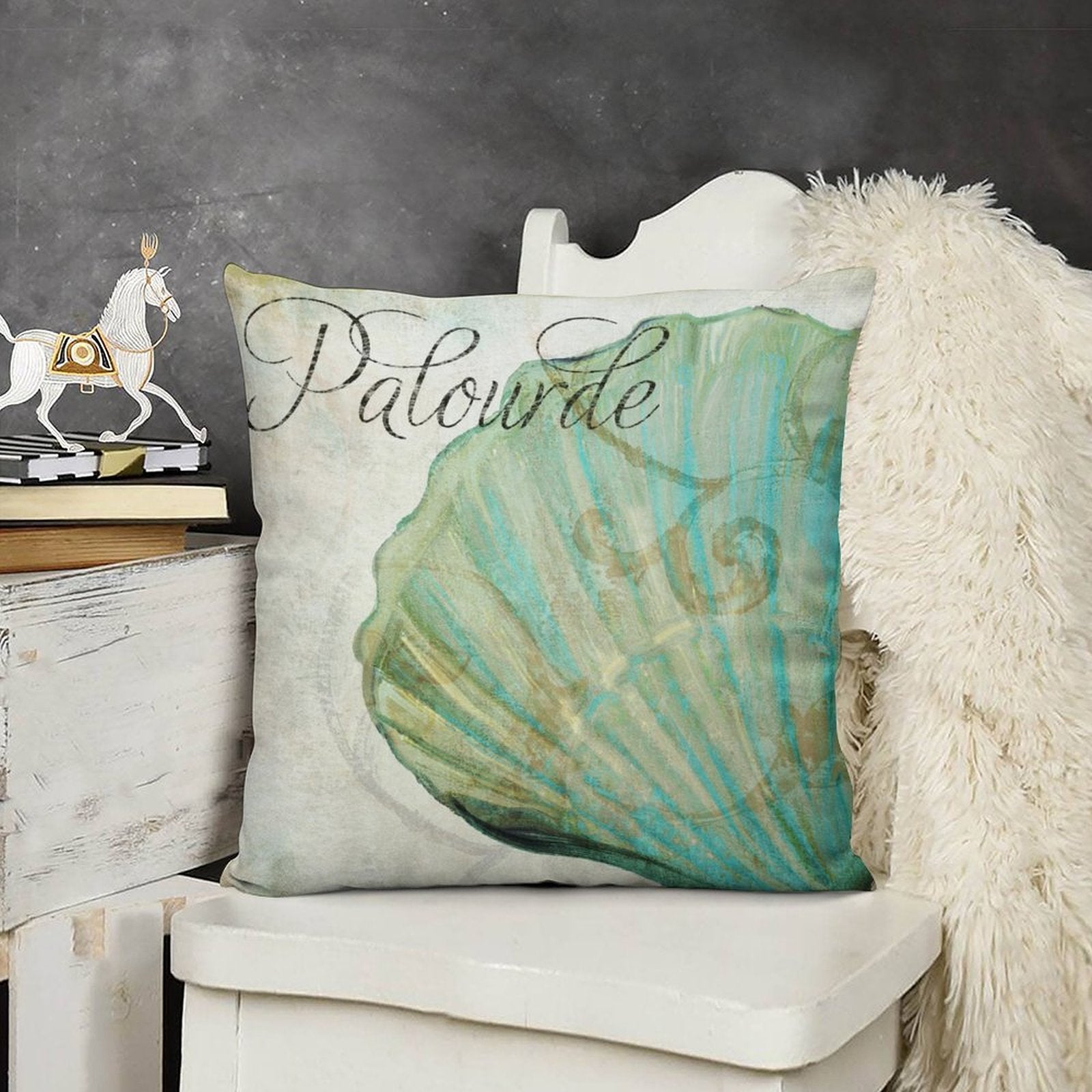 Plush pillow cover with teal seashell design and "Palourde" text. Soft, decorative pillow cover.