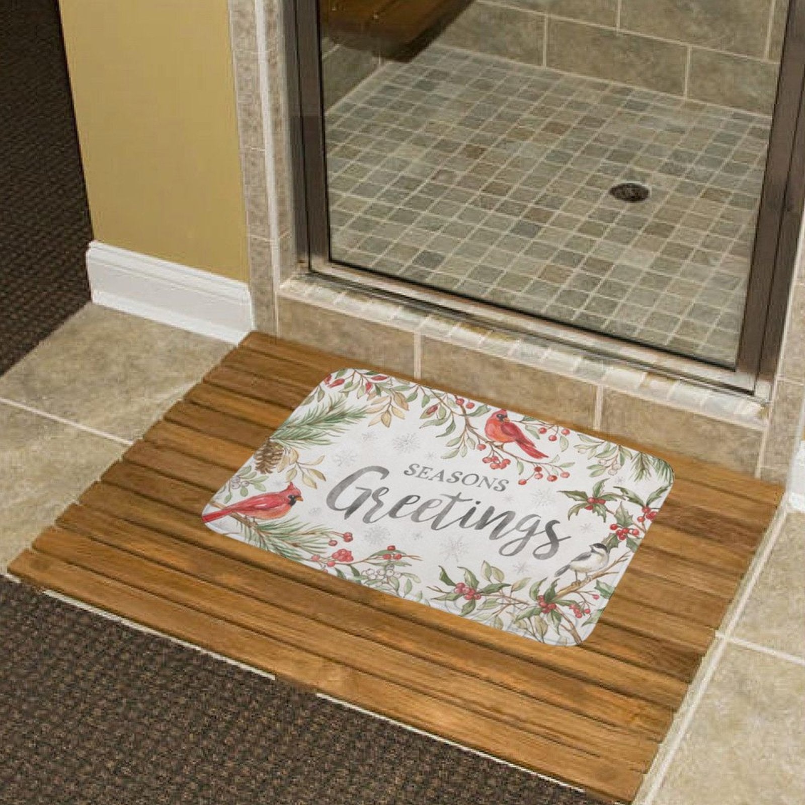 Seasons Greetings bath rug with cardinal birds and pine branches on a wooden floor mat, bathroom decor