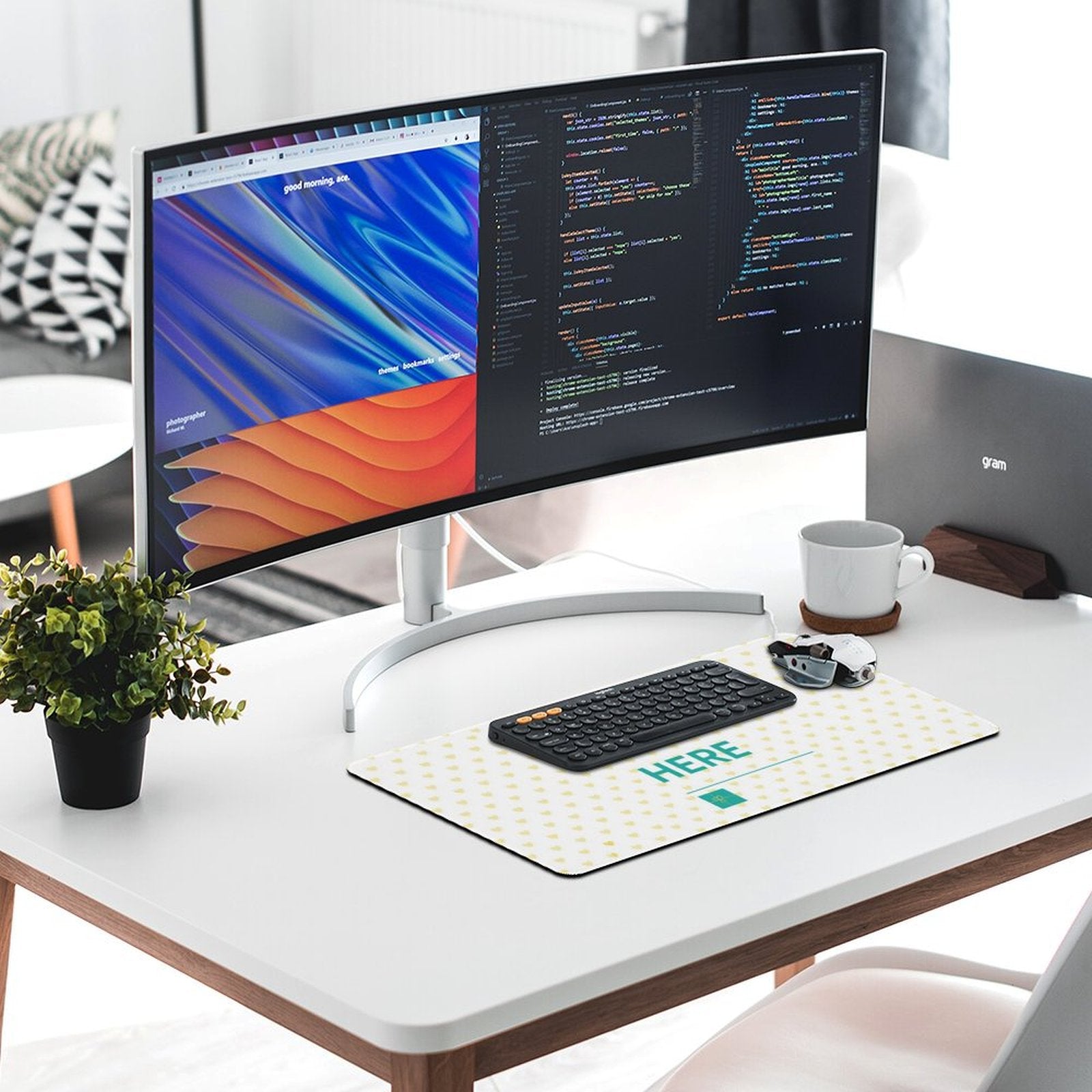Personalized mousepad with heart pattern and 'HERE' text, paired with keyboard and monitor, creating a stylish office setup.
