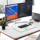 Personalized mousepad with heart pattern and 'HERE' text, paired with keyboard and monitor, creating a stylish office setup.