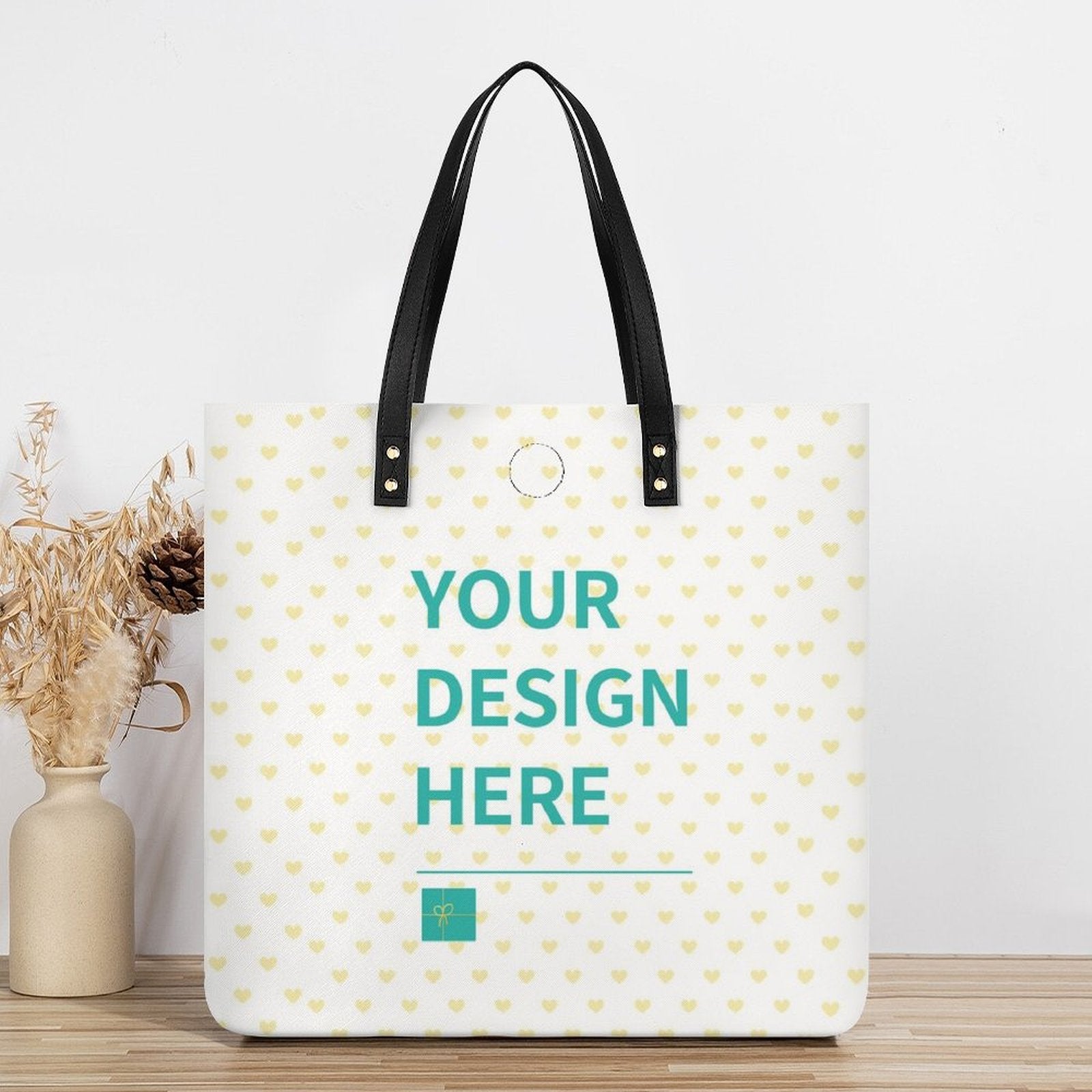 Personalized PU leather tote bag with heart design and black handles, featuring 'YOUR DESIGN HERE', for shopping and work.
