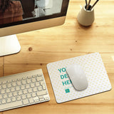 Customizable desk writing pad with YOUR DESIGN HERE text, white mouse, and keyboard setup for office or home use.