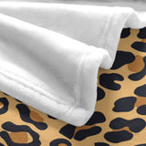 Animal skin flannel blanket in leopard print, with soft, cozy white fabric, perfect for home decor.