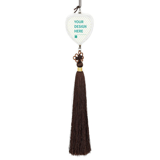 Customizable glass car pendant with a heart shape, featuring "YOUR DESIGN HERE" and brown tassel.