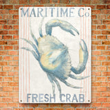 Metal sign, nautical themed kitchen decor, featuring a watercolor crab with Maritime Co. Fresh Crab text, on brick wall.