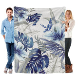 Blue Tropical Plants Flannel Blanket, soft polyester, made in USA, held by two people